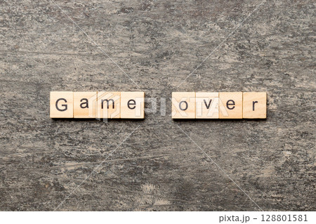game over word written on wood block. game over text on table, concept 128801581
