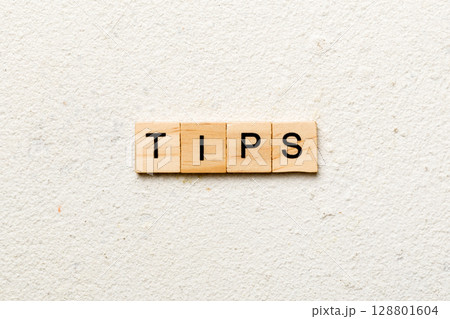 tips word written on wood block. tips text on table, concept 128801604