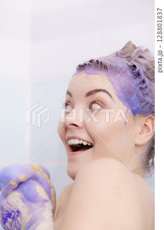 Woman applying toner shampoo on her hair 128801837