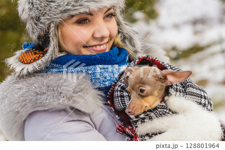 Woman hug warming her little dog in winter 128801964