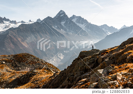Monte Bianco mountains rise beyond hiker in foreground Monte Bianco mountains rise beyond hiker in foreground 128802033