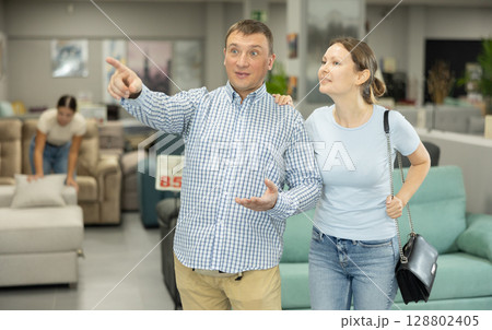 Couple visiting store in search of new furnishings for apartment Couple visiting store in search of new furnishings for apartment 128802405