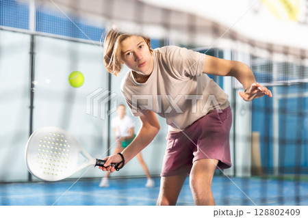 Portrait of a guy tennis player playing padel Portrait of a guy tennis player playing padel 128802409