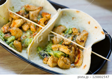 Chicken taco with mexican sauce is tasty tradition of Maxico Chicken taco with mexican sauce is tasty tradition of Maxico 128802547