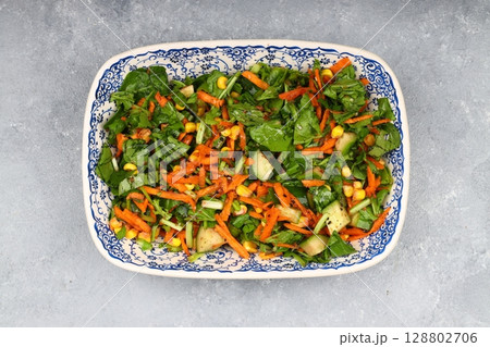 Mixed fresh Turkish salad. Carrots, arugula, cucumber, basil, pepper, black cumin, pepper, corn and plenty of olive oil in a serving plate. Healthy summer food. Mixed fresh Turkish salad. Carrots, arugula, cucumber, basil, pepper, black cumin, pepper, corn and plenty of olive oil in a serving plate. Healthy summer food. 128802706