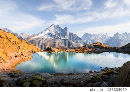 Crystal-clear Lac Blanc reflects sky and Mont Blanc range in French Alps Crystal-clear Lac Blanc reflects sky and Mont Blanc range in French Alps 128803039