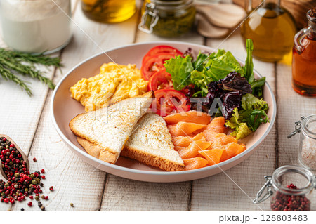 Breakfast with scrambled eggs and salmon 128803483