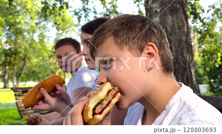 school children eat big hamburger, kids eat burger park, group children friends eat cutlet bun, Kids Enjoying Burgers in the Park, Summer Picnic Delight, Friends Eating Fast Food Together, Childhood school children eat big hamburger, kids eat burger park, group children friends eat cutlet bun, Kids Enjoying Burgers in the Park, Summer Picnic Delight, Friends Eating Fast Food Together, Childhood 128803693