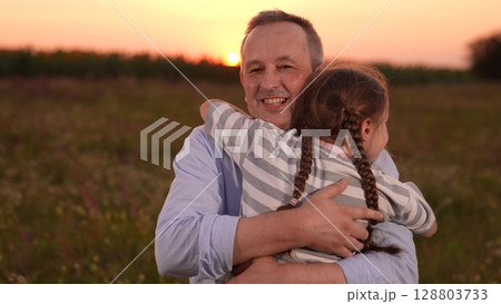 child girl kid childhood outdoors, father man parent male, Father and daughter hug at sunset, Close family bond outdoors, Emotional embrace in nature, Loving father and happy child, Warm sunset in the child girl kid childhood outdoors, father man parent male, Father and daughter hug at sunset, Close family bond outdoors, Emotional embrace in nature, Loving father and happy child, Warm sunset in the 128803733