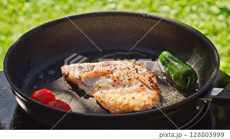fresh fish fillet on hot pan 128803999