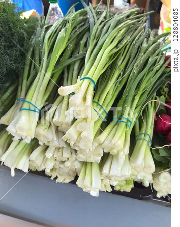 Freshly harvested green onions stacked at a farmers market in spring Freshly harvested green onions stacked at a farmers market in spring 128804085