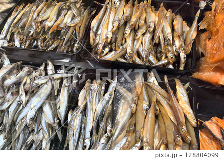 Vendors showcase a vibrant selection of freshly caught fish at a local market Vendors showcase a vibrant selection of freshly caught fish at a local market 128804099