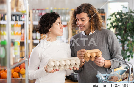 Couple picking eggs Couple picking eggs 128805895