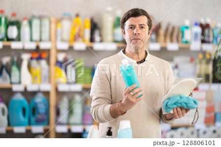 man buys shower gel and washcloths 128806101