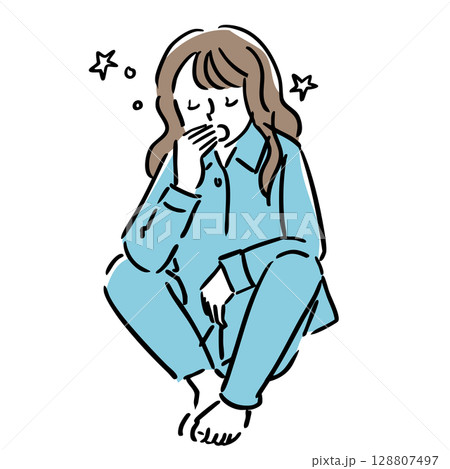座りながら眠くてあくびをするパジャマ姿の女性 128807497