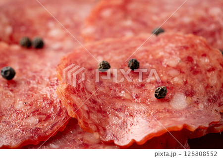 ブラックペッパーがかかったサラミのスライスのクローズアップ ブラックペッパーがかかったサラミのスライスのクローズアップ 128808552
