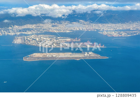 Aerial view of the Kansai International Airport (KIX) with izumisano city in background. 128809435
