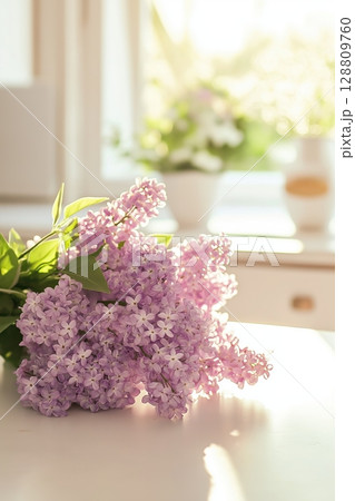 Lilac bouquet on a sunny table with soft light 128809760