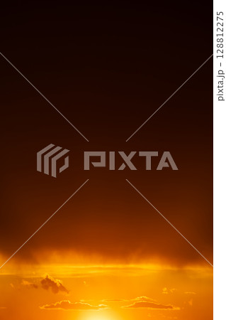 Sunset sky with vibrant orange and red clouds. 128812275