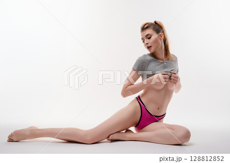 Elegance and poise of a woman in a beauty studio setting 128812852