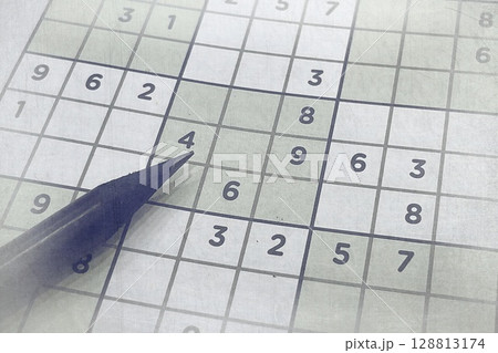 Pen on Partially Solved Sudoku Puzzle. Logic Game for Mental Focus and Brain-Boosting Entertainment 128813174
