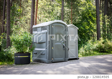 Portable Toilets in Forest Park Setting for Outdoor Events or Public Convenience Infrastructure 128814505
