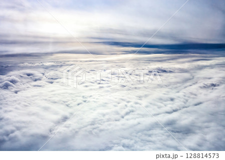 Stratiform clouds. Aerial view of fluffy white blanket cloud stretching across sky Stratiform clouds. Aerial view of fluffy white blanket cloud stretching across sky 128814573