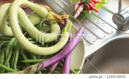 Unusually shaped vegetables on plate. Zucchini and eggplant, asparagus beans and peppers. Seasonal food and farm organic produce. Unusually shaped vegetables on plate. Zucchini and eggplant, asparagus beans and peppers. Seasonal food and farm organic produce. 128814643
