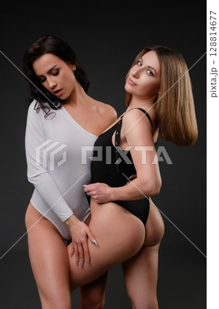 Two women pose in sensual lingerie showcasing beauty and elegance Two women pose in sensual lingerie showcasing beauty and elegance 128814677