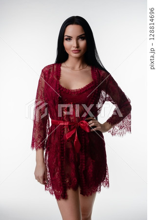 Elegant woman posing in red lingerie in a bright studio environment 128814696