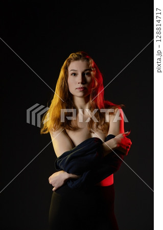 Woman dancing in soft light with a captivating mix of beauty and grace Woman dancing in soft light with a captivating mix of beauty and grace 128814717