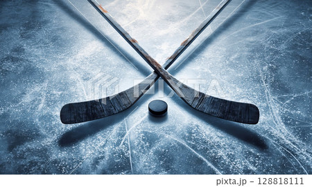 Crossed hockey sticks and pucks on textured ice background, subtle frost patterns and light shadows 128818111