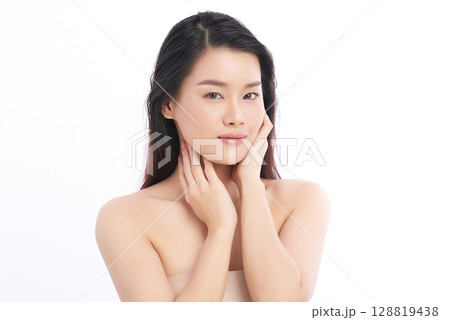 A beautiful young Asian woman with clean, fresh skin against a white background. Skincare, facial treatment, cosmetology, beauty, and spa. An elegant portrait of an Asian woman. A beautiful young Asian woman with clean, fresh skin against a white background. Skincare, facial treatment, cosmetology, beauty, and spa. An elegant portrait of an Asian woman. 128819438