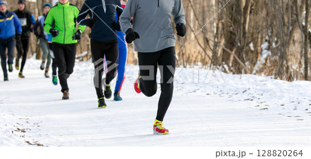 group runners athletes in winter race or marathon on snow-covered trail group runners athletes in winter race or marathon on snow-covered trail 128820264