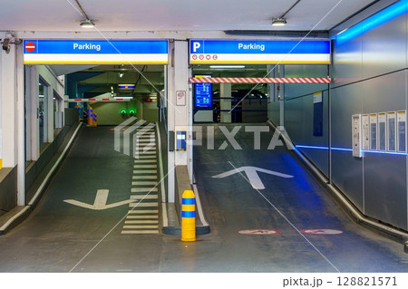 Parking Garage Entrance with Directional Arrows and Signage for Vehicle Access Control Parking Garage Entrance with Directional Arrows and Signage for Vehicle Access Control 128821571