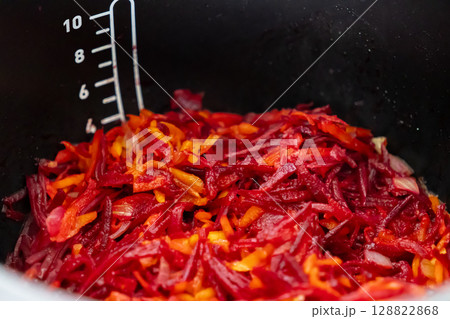 Vibrant shredded beetroot, carrot, and onion inside a multi-cooker pot, prepared for cooking healthy, nutritious homemade meals for the family Vibrant shredded beetroot, carrot, and onion inside a multi-cooker pot, prepared for cooking healthy, nutritious homemade meals for the family 128822868