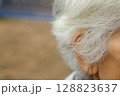 The elderly man's white hair is starting to grow long. 128823637