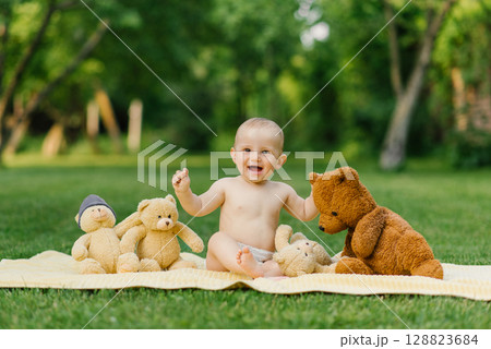 Baby Playing With Teddy Bears On Blanket Outdoors Baby Playing With Teddy Bears On Blanket Outdoors 128823684