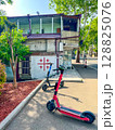 Tbilisi, Georgia - May 02, 2025: Two electric scooters near the wall with the Georgian national flag. High quality photo 128825076