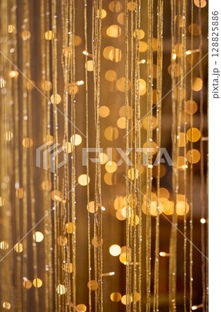 Golden Bokeh Background with Shimmering Threads 128825886