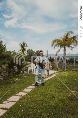 Accordion Player Walking Under The Blue Sky 128825981