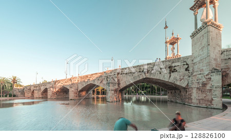 Pont de la Mar bridge timelapse in Valencia, Spain, ornate architecture reflected in a tranquil pond. Pont de la Mar bridge timelapse in Valencia, Spain, ornate architecture reflected in a tranquil pond. 128826100