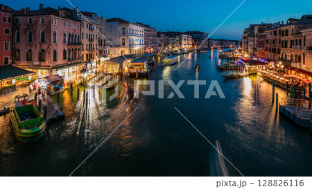 Grand Canal in Venice, Italy day to night timelapse. Gondolas and city lights from Rialto Bridge. 128826116