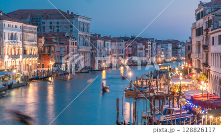 Grand Canal in Venice, Italy day to night timelapse. Gondolas and city lights from Rialto Bridge. Grand Canal in Venice, Italy day to night timelapse. Gondolas and city lights from Rialto Bridge. 128826117