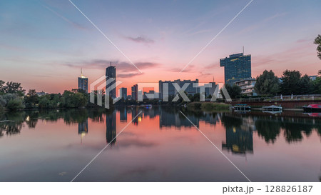 Vienna international center skyscrapers with Kaiserwasser lake reflection view day to night timelapse 128826187