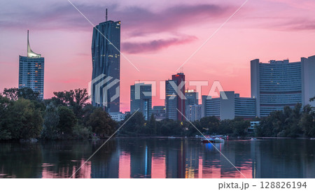 Vienna international center skyscrapers with Kaiserwasser lake reflection view day to night timelapse Vienna international center skyscrapers with Kaiserwasser lake reflection view day to night timelapse 128826194