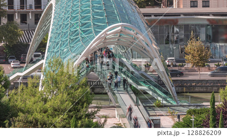 Timelapse of the Bridge of Peace, a bow-shaped pedestrian bridge in Tbilisi, Georgia 128826209