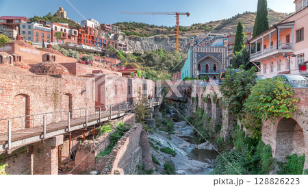 Abanotubani district in Old Tbilisi, Georgia where most of the Sulphur baths are located aerial timelapse. 128826223