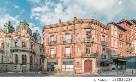 Panorama showing historic brick facades at Rue du Languedoc and Theodore Ozenne intersection timelapse in Toulouse, France. 128826257
