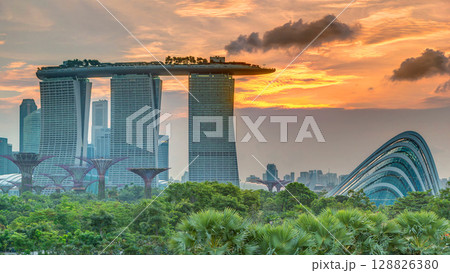 Marina Bay Sands, Gardens by the bay with cloud forest, flower dome and supertrees at sunset timelapse 128826380